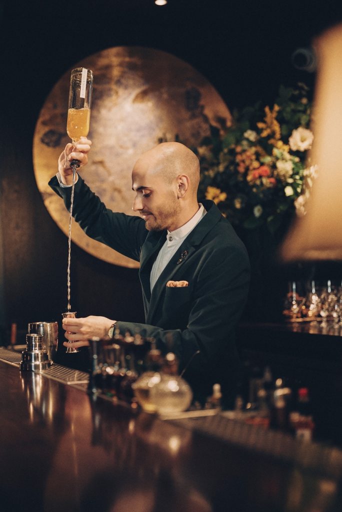 A server mixing a cocktail