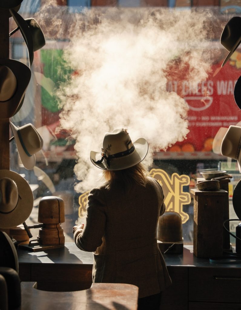 A woman crafting a hat by hand