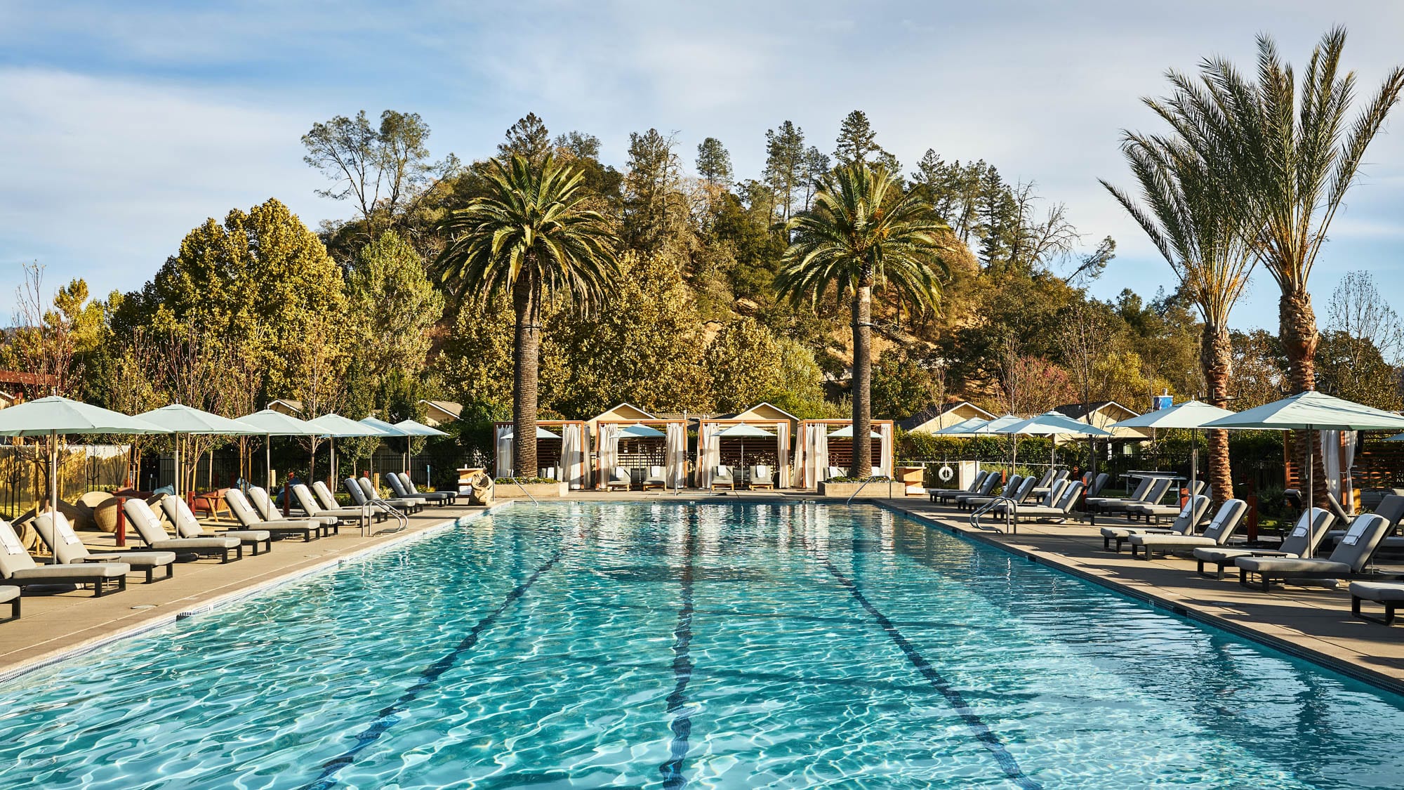 Lounge chairs around a pool at one of the best wellness retreats in Napa Valley, CA.